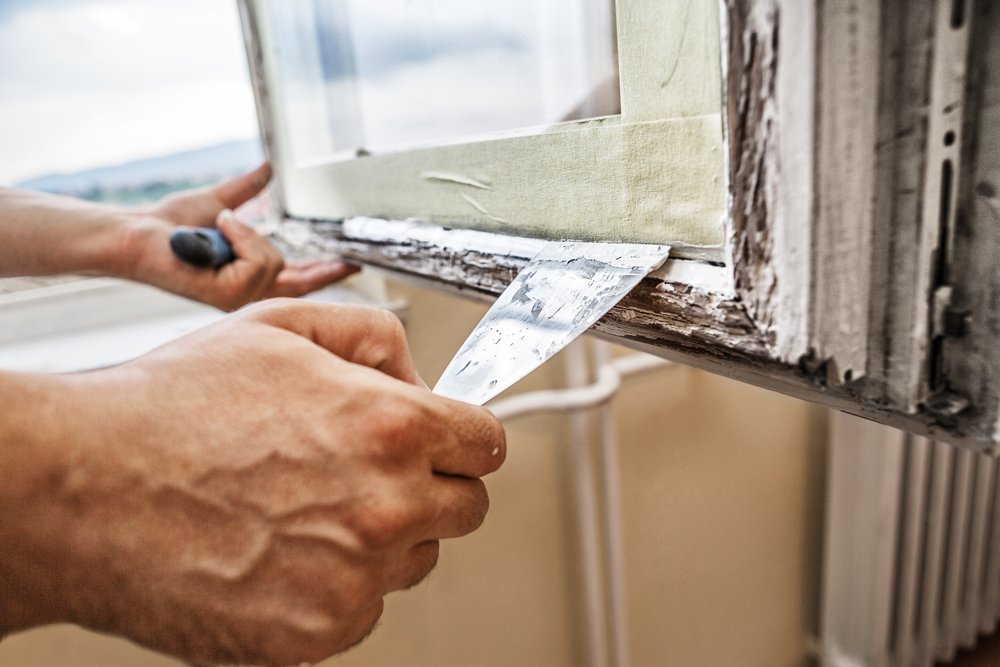a man from a glass repair company fixing a window