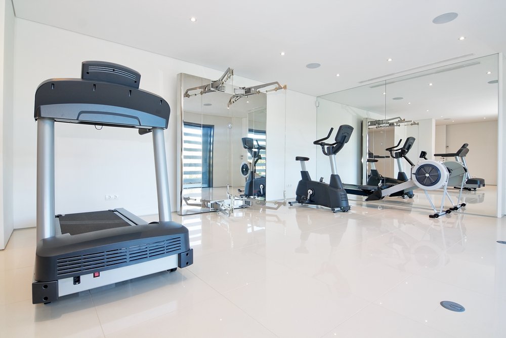 a home gym with mirrors on the wall